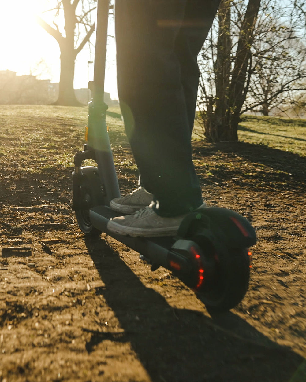 a man riding electric scooter on a muddy ground
