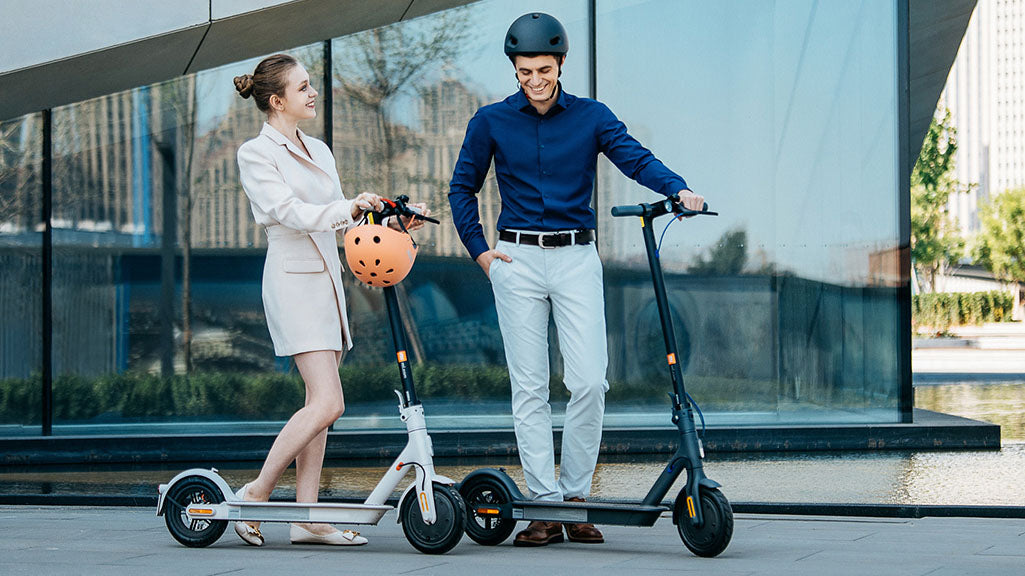 two people with xiaomi electric scooters talking