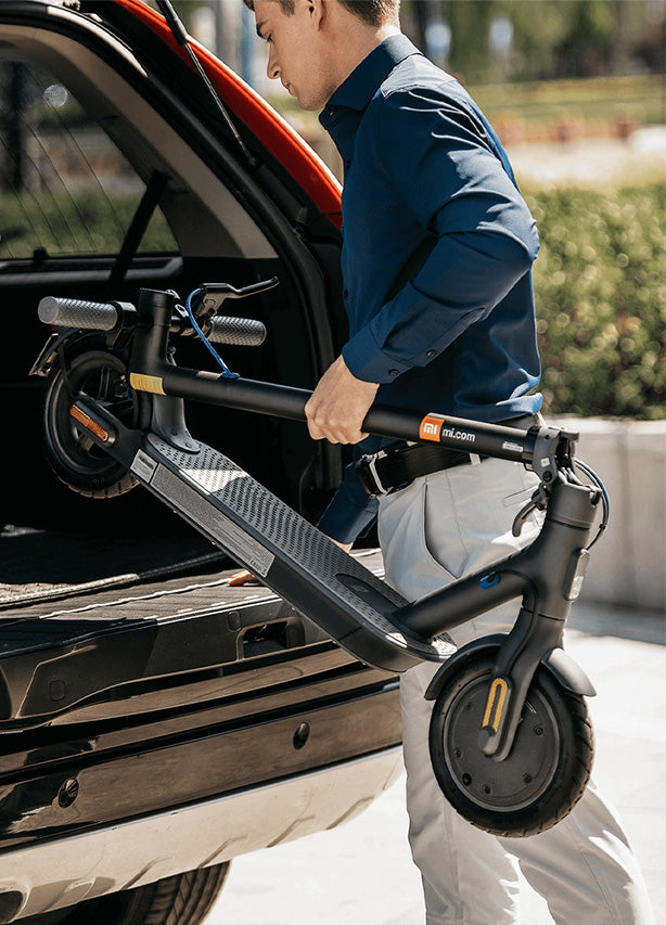 Xiaomi electric scooter folded placed in to trunk in a car